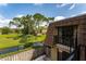 Scenic backyard view from the second-story balcony showcasing the green space, pond, and exterior of the property at 5287 Cypress Ct # 724, Orlando, FL 32811