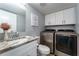 Bathroom with modern washer and dryer, stylish vanity, and ample storage at 5287 Cypress Ct # 724, Orlando, FL 32811
