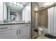 Bathroom with white vanity, granite countertop, large mirror, and shower over tub with tile surround at 5287 Cypress Ct # 724, Orlando, FL 32811