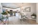 Bright kitchen with stainless appliances, white cabinetry, tile floor, and a glass dining table beneath a stylish chandelier at 5287 Cypress Ct # 724, Orlando, FL 32811