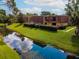 A tranquil water view showcases the building's surroundings and lush greenery at 5287 Cypress Ct # 724, Orlando, FL 32811