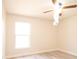 Bedroom with window, neutral walls and gray wood floors at 6569 Long Breeze N Rd, Orlando, FL 32810