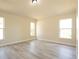 Bright bedroom with hardwood floors and two windows providing natural light at 6569 Long Breeze N Rd, Orlando, FL 32810