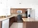 Well-lit kitchen featuring granite countertops, stainless steel appliances, and ample cabinet space at 6569 Long Breeze N Rd, Orlando, FL 32810