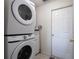 Laundry room featuring stacked washer and dryer unit at 6569 Long Breeze N Rd, Orlando, FL 32810