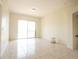Sunlit living room with tile flooring and sliding glass doors leading to the backyard at 6569 Long Breeze N Rd, Orlando, FL 32810