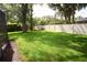 Spacious backyard featuring a well-maintained lawn, mature trees, a fence, and storage shed at 687 N Endeavour Dr, Winter Springs, FL 32708