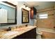 Bathroom with double vanity, tile backsplash, dark wood cabinets, and bathtub at 687 N Endeavour Dr, Winter Springs, FL 32708