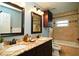 Bathroom with double vanity, tile backsplash, dark wood cabinets, and bathtub at 687 N Endeavour Dr, Winter Springs, FL 32708