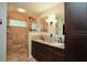 Bathroom with double vanity, granite countertop, travertine tiled shower and custom shower head at 687 N Endeavour Dr, Winter Springs, FL 32708