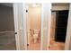 Bathroom with toilet, tile flooring, and walk-in closet with dark wood shelving at 687 N Endeavour Dr, Winter Springs, FL 32708