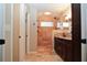 Bathroom with double vanity, granite countertop, travertine tiled shower and custom shower head at 687 N Endeavour Dr, Winter Springs, FL 32708