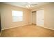 Light-filled bedroom with a window, closet, and plush carpeting at 687 N Endeavour Dr, Winter Springs, FL 32708