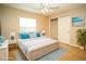 Bright bedroom with a large bed, ceiling fan, and beach themed artwork at 687 N Endeavour Dr, Winter Springs, FL 32708