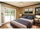 Staged bedroom features a bed, rug and view of lanai and pool at 687 N Endeavour Dr, Winter Springs, FL 32708