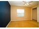 Neutral bedroom with a sliding closet door, window, and soft tan carpet at 687 N Endeavour Dr, Winter Springs, FL 32708