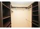 Walk-in closet with custom dark wood shelving and racks and white walls at 687 N Endeavour Dr, Winter Springs, FL 32708