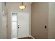 Bright foyer with wood floors and a glass paneled side light next to the front door at 687 N Endeavour Dr, Winter Springs, FL 32708