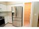 Stainless steel Samsung fridge with adjacent walk-in pantry for kitchen storage at 687 N Endeavour Dr, Winter Springs, FL 32708