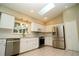 Bright kitchen boasts stainless steel appliances, white cabinetry, and ample natural light at 687 N Endeavour Dr, Winter Springs, FL 32708