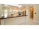 Modern kitchen featuring white cabinets, stainless steel appliances, and a breakfast bar at 687 N Endeavour Dr, Winter Springs, FL 32708