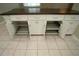 Kitchen island boasts modern cabinetry, with lots of built-in storage solutions and tile flooring at 687 N Endeavour Dr, Winter Springs, FL 32708