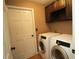 Featuring a washer and dryer, the laundry room has built in storage and easy backyard access at 687 N Endeavour Dr, Winter Springs, FL 32708