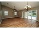 Open-concept living area with wood floors and sliding glass doors leading to a pool at 687 N Endeavour Dr, Winter Springs, FL 32708