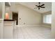 Open-plan living room featuring a ceiling fan, natural light, and tiled floors throughout at 687 N Endeavour Dr, Winter Springs, FL 32708