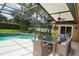 Outdoor patio with a dining area, ceiling fan, and screened-in pool at 687 N Endeavour Dr, Winter Springs, FL 32708