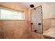 Shower features travertine tile, window and custom bronze shower screen at 687 N Endeavour Dr, Winter Springs, FL 32708