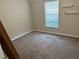 Neutral bedroom with plush carpeting, natural light, and minimalist decor at 7047 Sw 131St Loop, Ocala, FL 34473