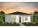 Charming single-story home featuring a modern front door, neutral colors, and tropical landscaping at 7125 Rosy Sky Ave, Orlando, FL 32829
