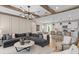 Open concept living room and kitchen with wood beams, modern design, and ample seating at 7125 Rosy Sky Ave, Orlando, FL 32829