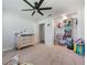 Bedroom with ceiling fan, carpet, changing table, walk-in closet at 7852 Broken Arrow Trl, Winter Park, FL 32792