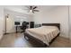 Bedroom featuring a comfortable bed, desk, and hardwood floors at 7852 Broken Arrow Trl, Winter Park, FL 32792