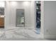 Hallway featuring marble flooring, a vanity, large mirror and a closet at 7852 Broken Arrow Trl, Winter Park, FL 32792