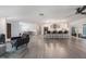 Expansive open-concept kitchen with island seating, modern lighting, and light wood flooring at 7852 Broken Arrow Trl, Winter Park, FL 32792