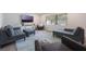 Bright and airy living room with large window, calming colors, and lots of comfortable seating at 7852 Broken Arrow Trl, Winter Park, FL 32792