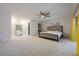 Spacious bedroom with large window, walk-in closet, ceiling fan, and access to the screened patio at 7852 Broken Arrow Trl, Winter Park, FL 32792