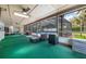 A screened in lanai with lounge seating and a view of the pool at 7852 Broken Arrow Trl, Winter Park, FL 32792
