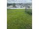 Spacious backyard featuring lush green grass and a white fence, perfect for outdoor activities and privacy at 798 Kapi Dr, Groveland, FL 34736