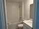 Clean bathroom featuring white tile, a shower-tub combo, and a vanity at 798 Kapi Dr, Groveland, FL 34736