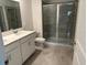 Modern bathroom featuring a double sink vanity and glass-enclosed shower at 798 Kapi Dr, Groveland, FL 34736