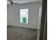 Bright bedroom with plush carpeting and a window overlooking the neighborhood at 798 Kapi Dr, Groveland, FL 34736