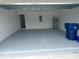 Clean, freshly painted garage with ample space for parking and storage, featuring a water heater at 798 Kapi Dr, Groveland, FL 34736