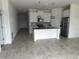 Modern kitchen with white cabinets, stainless steel appliances, and large island at 798 Kapi Dr, Groveland, FL 34736