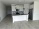Modern kitchen with white cabinets, stainless steel appliances, and large island at 798 Kapi Dr, Groveland, FL 34736