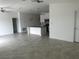 Spacious living area with neutral tones, ceiling fan, and adjacent kitchen at 798 Kapi Dr, Groveland, FL 34736