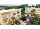 Aerial view of yellow townhomes with red tile roofs and well-maintained landscaping at 8024 Cool Breeze Dr # 132, Orlando, FL 32819
